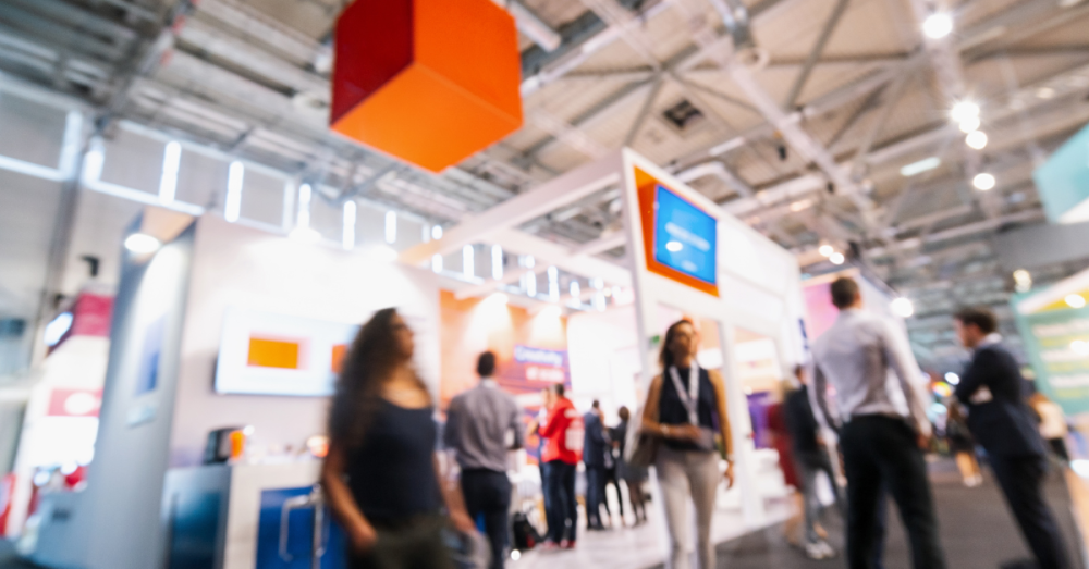 people walking around on a trade show floor